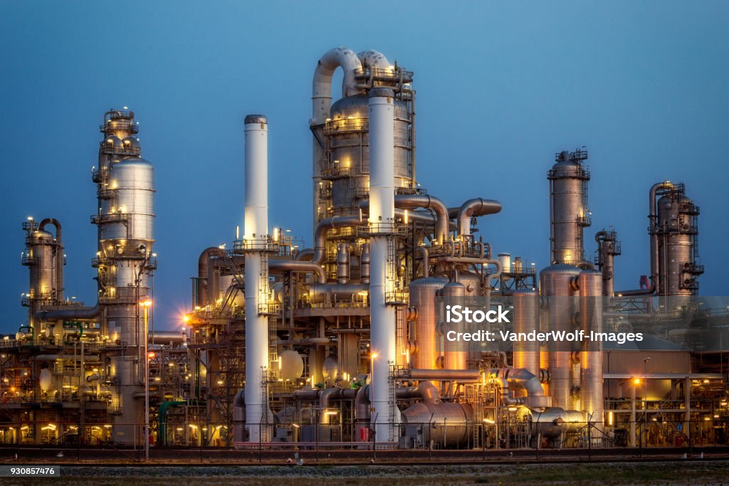 Oil refinery industrial petrochemical plant factory after sunset.